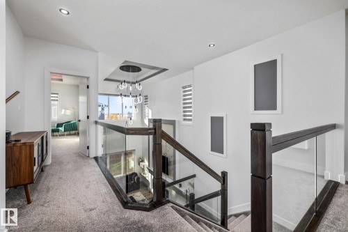 Stairs with carpet flooring, a chandelier, and recessed lighting - 5304 Kimball Place, Edmonton, AB - Indoor Photo Showing Other Room