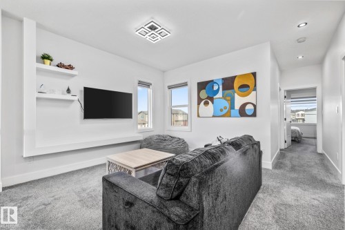 Living room featuring light carpet, plenty of natural light, and recessed lighting - 5304 Kimball Place, Edmonton, AB - Indoor Photo Showing Living Room