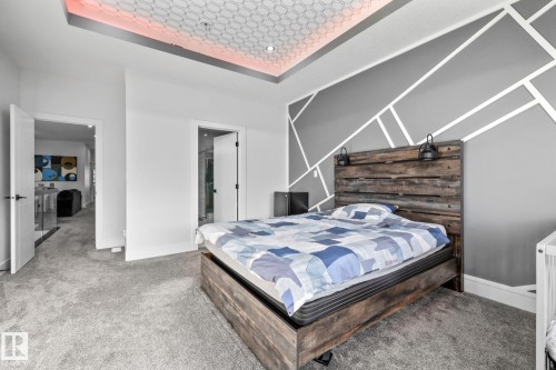 Bedroom featuring a tray ceiling, carpet, and ensuite bathroom - 5304 Kimball Place, Edmonton, AB - Indoor Photo Showing Bedroom