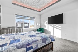 Bedroom featuring a tray ceiling and carpet - 
