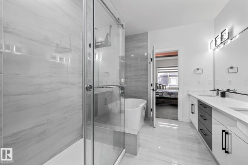 Full bathroom featuring ensuite bath, double vanity, a freestanding bath, and a marble finish shower - 5304 Kimball Place, Edmonton, AB - Indoor Photo Showing Bathroom