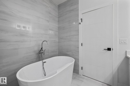 Bathroom with vanity, a soaking tub, and tile walls - 5304 Kimball Place, Edmonton, AB - Indoor Photo Showing Bathroom