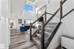 Stairs with a high ceiling, healthy amount of natural light, and wood finished floors - 