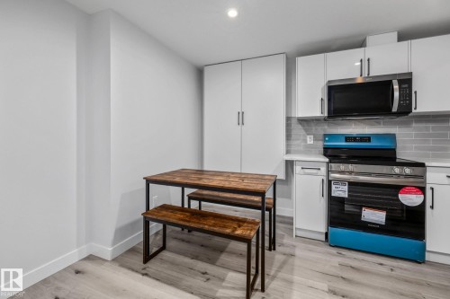 Kitchen featuring stainless steel appliances, white cabinetry, tasteful backsplash, recessed lighting, and light wood finished floors - 5304 Kimball Place, Edmonton, AB - Indoor Photo Showing Kitchen