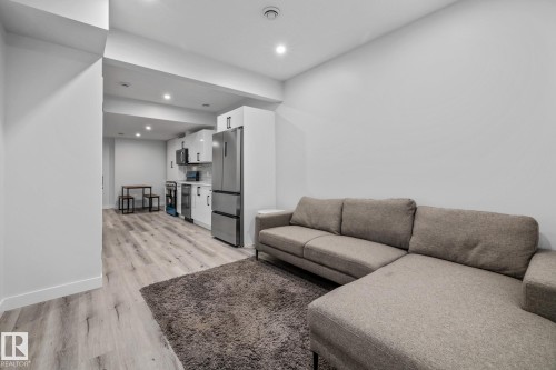 Living area featuring light wood-style floors and recessed lighting - 5304 Kimball Place, Edmonton, AB - Indoor