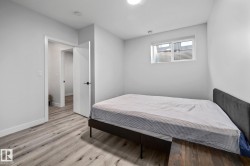 Bedroom with wood finished floors and baseboards - 