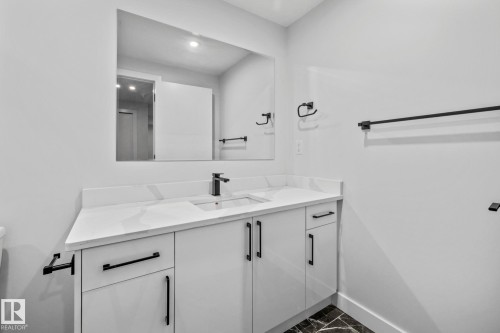 Bathroom featuring vanity and baseboards - 5304 Kimball Place, Edmonton, AB - Indoor Photo Showing Bathroom