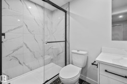 Full bath with vanity and a marble finish shower - 