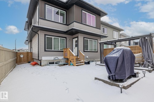 Snow covered back of property with a fenced backyard and a patio - 5304 Kimball Place, Edmonton, AB - Outdoor With Exterior