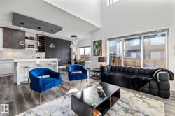 Living room with wood finished floors and a high ceiling - 