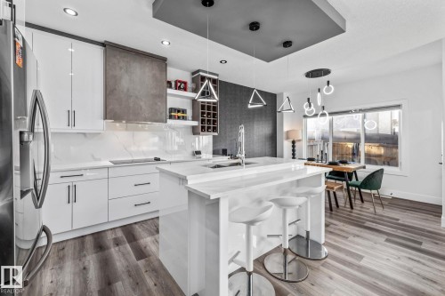Kitchen with white cabinets, open shelves, modern cabinets, decorative light fixtures, and recessed lighting - 5304 Kimball Place, Edmonton, AB - Indoor Photo Showing Kitchen With Upgraded Kitchen