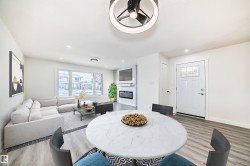Dining area with wood finished floors, a fireplace, and recessed lighting - 