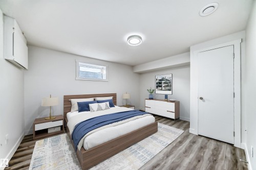 Bedroom with wood finished floors and baseboards - 14505 23 Street Nw, Edmonton, AB - Indoor Photo Showing Bedroom