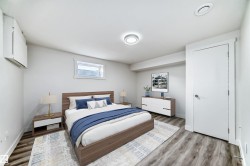Bedroom with wood finished floors and baseboards - 