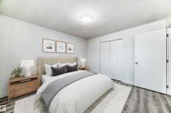 Bedroom featuring a closet and wood finished floors - 