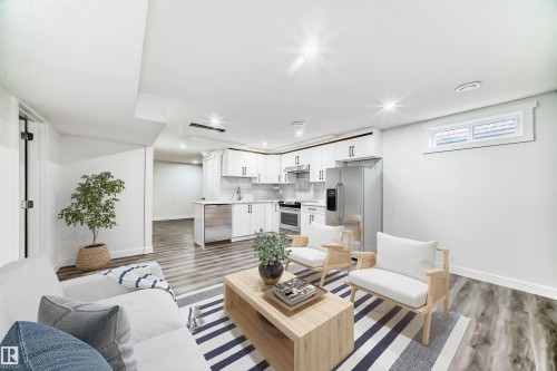 Living room with light wood-style flooring and recessed lighting - 14505 23 Street Nw, Edmonton, AB - Indoor