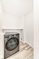 Laundry room featuring washer / dryer and light wood finished floors - 