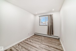 Spare room featuring a baseboard radiator, light wood-type flooring, and recessed lighting - 
