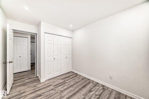 Unfurnished bedroom featuring wood finished floors, a closet, and recessed lighting - 4B 13230 Fort Road, Edmonton, AB - Indoor Photo Showing Other Room