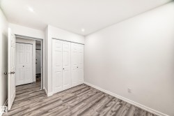 Unfurnished bedroom featuring wood finished floors, a closet, and recessed lighting - 