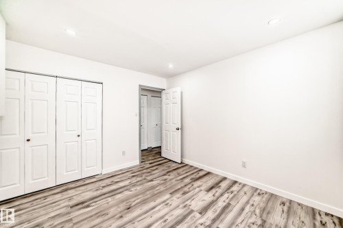 Unfurnished bedroom with a closet, light wood-style floors, and recessed lighting - 4B 13230 Fort Road, Edmonton, AB - Indoor Photo Showing Other Room