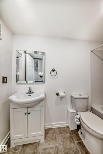 Full bath with vanity, shower / bathtub combination, and light tile patterned flooring - 4B 13230 Fort Road, Edmonton, AB - Indoor Photo Showing Bathroom