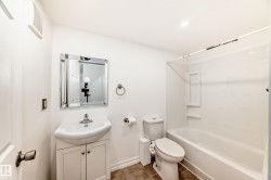 Bathroom with vanity, shower / tub combination, and recessed lighting - 