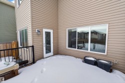 Snow covered patio with a deck - 