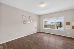 Empty room featuring wood finished floors and a textured ceiling - 