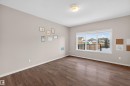 Empty room featuring wood finished floors and a textured ceiling - 4723 Alwood Bend Bend Sw, Edmonton, AB  - Indoor Photo Showing Other Room 