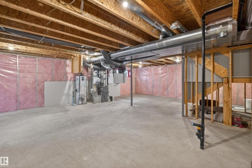 Unfinished below grade area featuring water heater and heating unit - 4723 Alwood Bend Bend Sw, Edmonton, AB - Indoor Photo Showing Basement