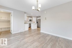Unfurnished living room featuring a chandelier, light wood-type flooring, and recessed lighting - 