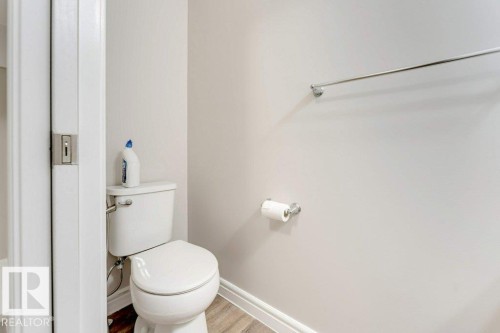 Bathroom with toilet and wood finished floors - 1423 24 Street, Edmonton, AB - Indoor Photo Showing Bathroom