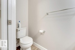Bathroom with toilet and wood finished floors - 