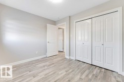 Unfurnished bedroom with a closet, light wood-style floors, and a textured ceiling - 