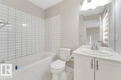 Bathroom with vanity and tub / shower combination - 