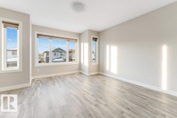 Spare room featuring light wood-type flooring and baseboards - 