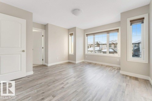 Empty room featuring baseboards and light wood-type flooring - 1423 24 Street, Edmonton, AB - Indoor Photo Showing Other Room