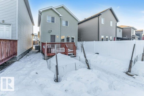 Snow covered property with a fenced backyard and a wooden deck - 1423 24 Street, Edmonton, AB - Outdoor With Deck Patio Veranda With Exterior