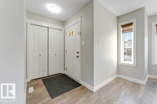 Entrance foyer featuring a textured ceiling and light wood-style floors - 1423 24 Street, Edmonton, AB - Indoor Photo Showing Other Room