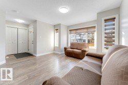 Living area with light wood finished floors and a textured ceiling - 