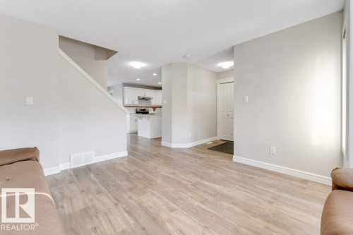 Unfurnished living room with light wood-type flooring and baseboards - 1423 24 Street, Edmonton, AB - Indoor