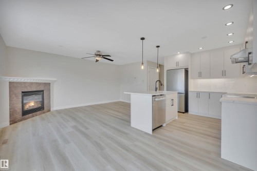 Kitchen with white cabinetry, an island with sink, open floor plan, recessed lighting, and pendant lighting - 457 Aster Close, Leduc, AB - Indoor Photo Showing Kitchen