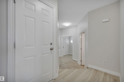 Hallway with baseboards and light wood-type flooring - 457 Aster Close, Leduc, AB - Indoor Photo Showing Other Room