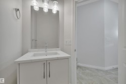 Bathroom with vanity and light tile patterned flooring - 