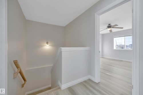 Stairs featuring wood finished floors and a ceiling fan - 457 Aster Close, Leduc, AB - Indoor Photo Showing Other Room