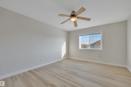 Empty room featuring light wood-style floors and a ceiling fan - 457 Aster Close, Leduc, AB - Indoor Photo Showing Other Room