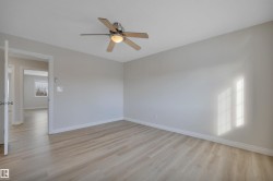 Spare room featuring light wood-style flooring and a ceiling fan - 