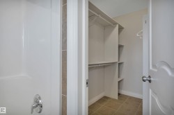 Spacious closet with light tile patterned floors - 