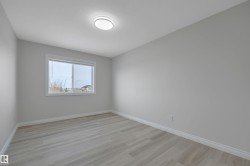 Unfurnished room featuring baseboards and light wood finished floors - 